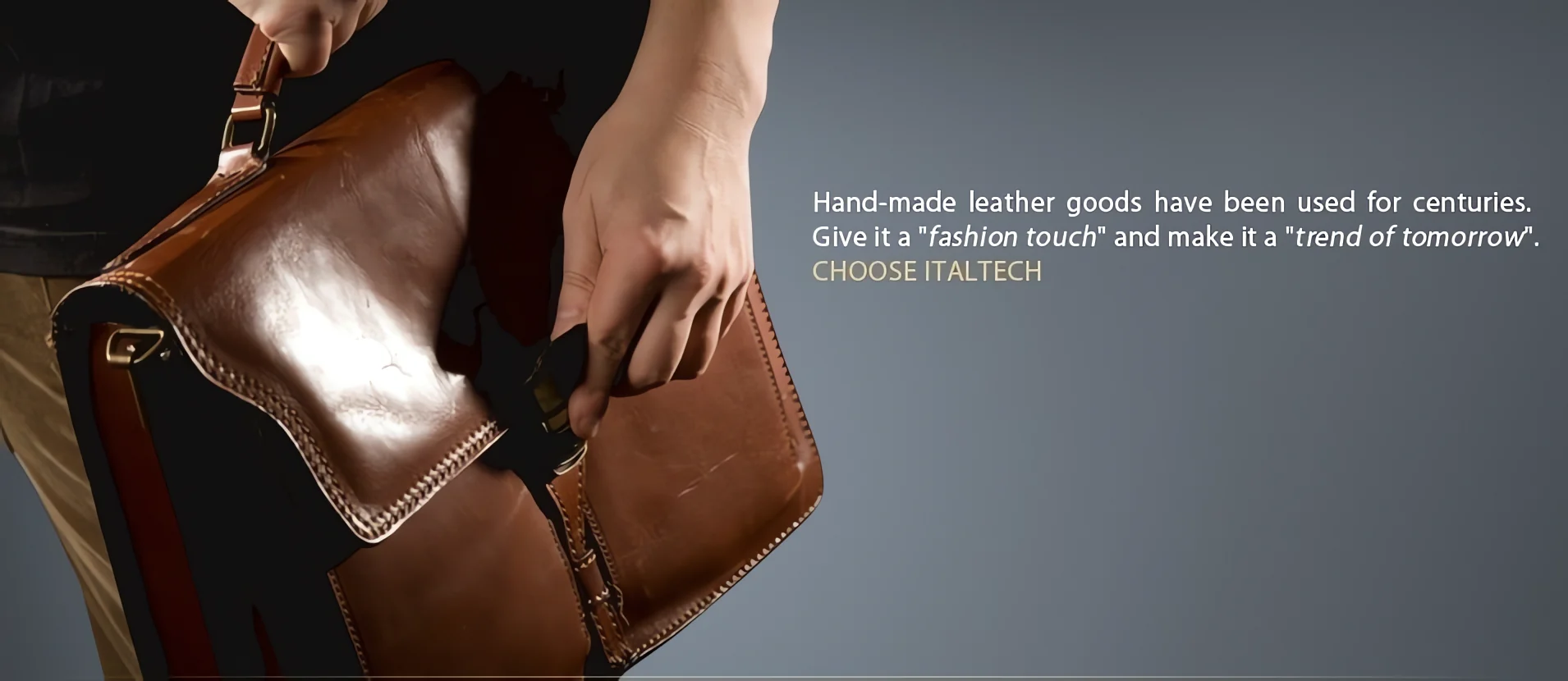 Hand holding a brown hand-made leather briefcase